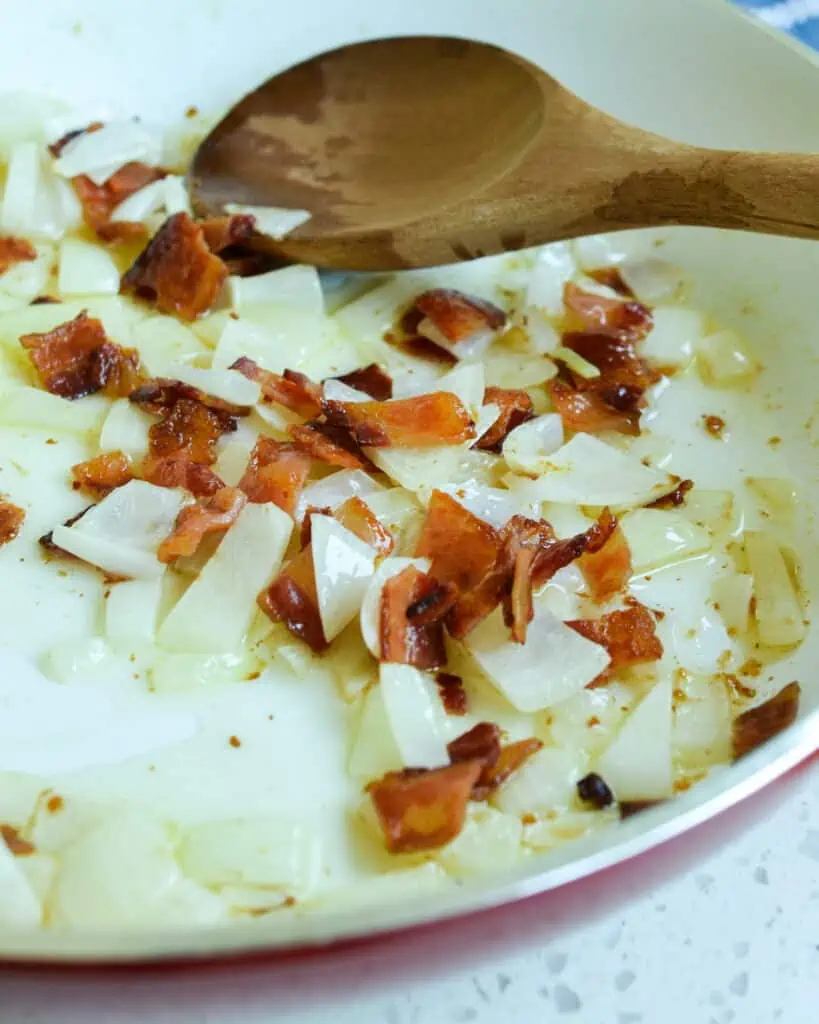 Southern Fried Cabbage starts with sautéed onions and bacon