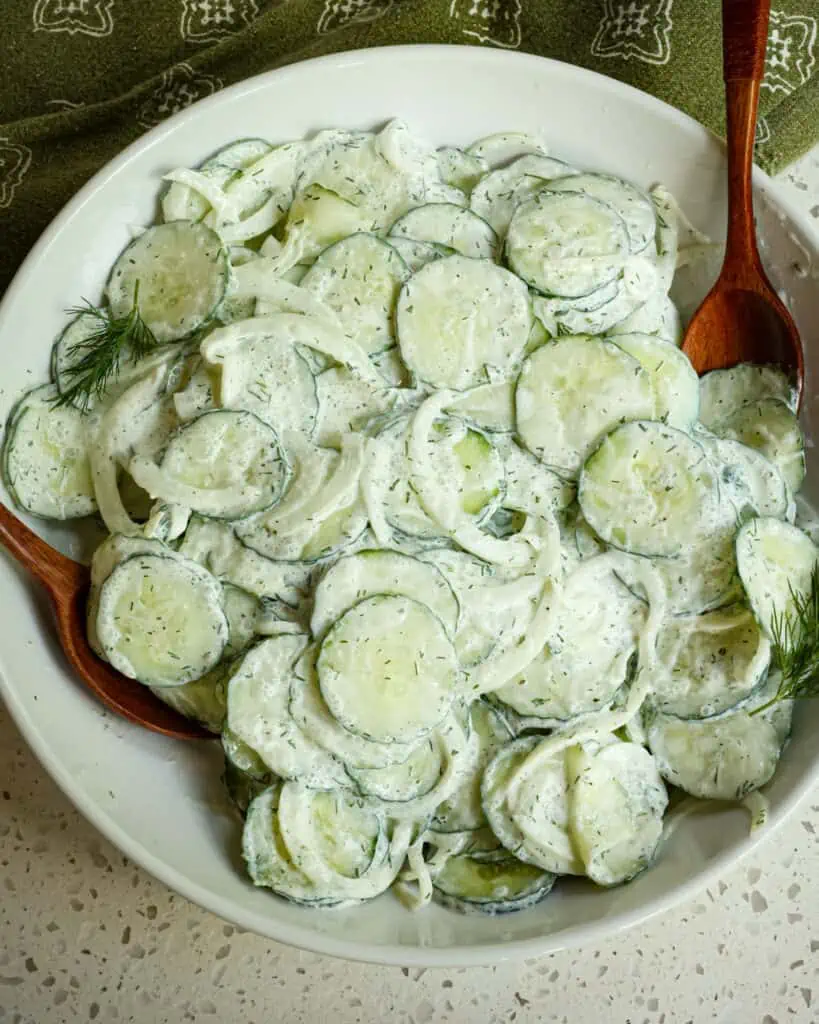 A delicious sour cream based German Cucumber Salad with onion made in less than fifteen minutes.  It is perfect for all your summer picnics, family reunions, and potlucks.