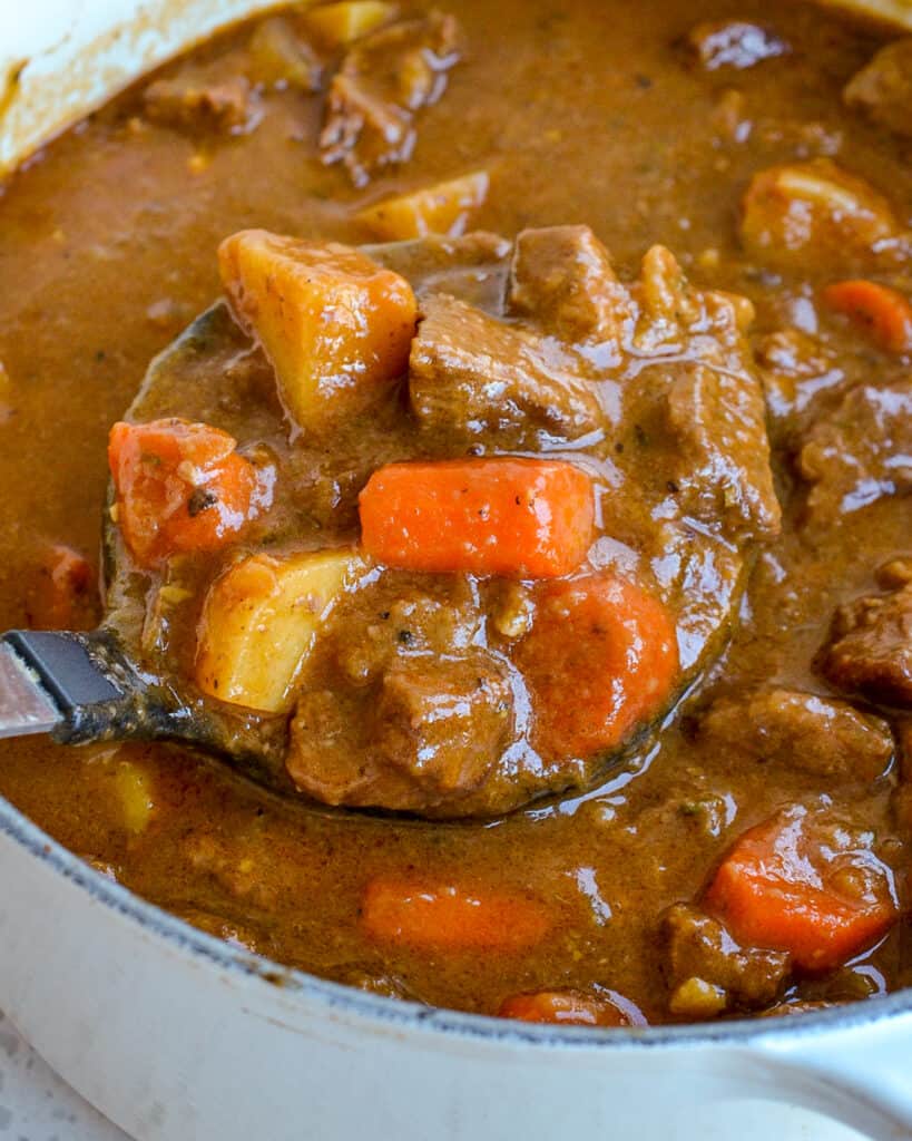 A warm rich and flavorful beef Irish stew with onions, potatoes, and carrots.