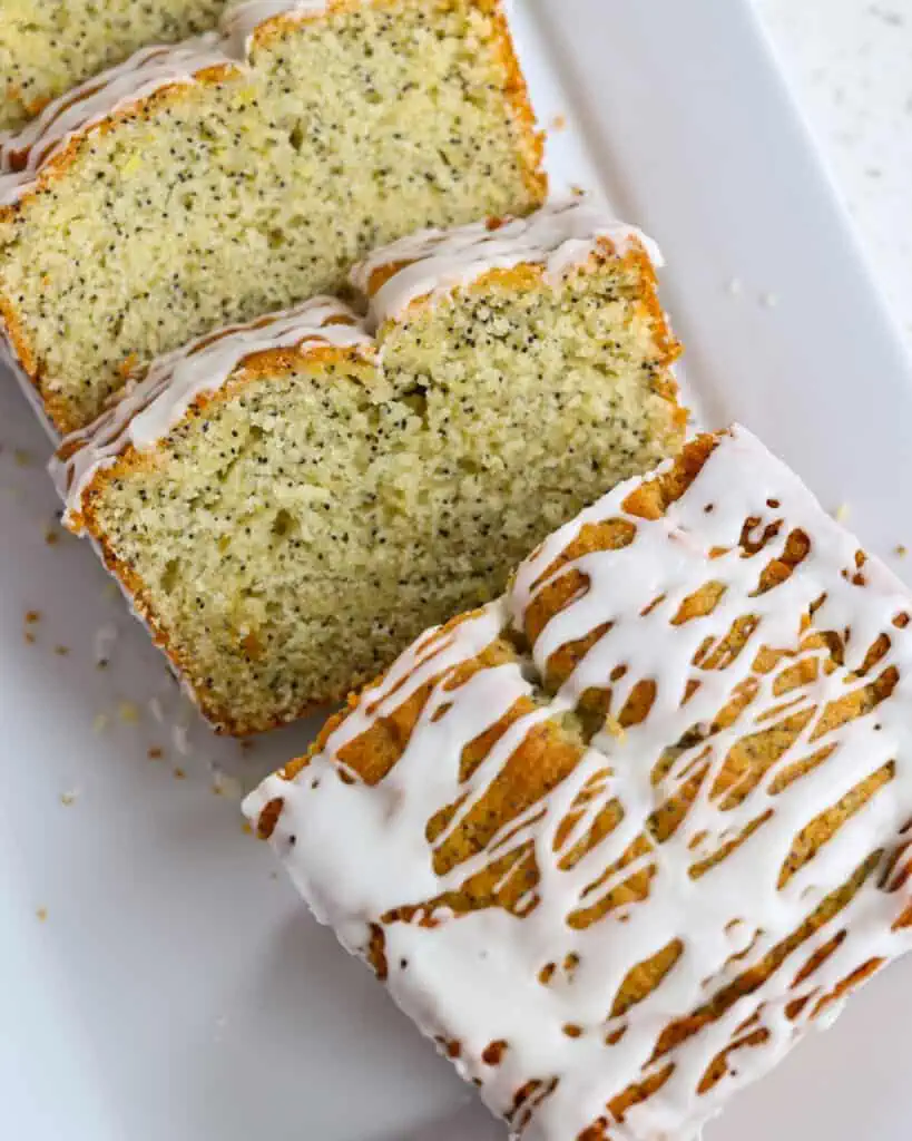 A scrumptious and moist Lemon Poppy Seed Bread baked with fresh lemon juice, lemon zest, poppy seeds, and sour cream all drizzled with an easy two ingredient glaze.  