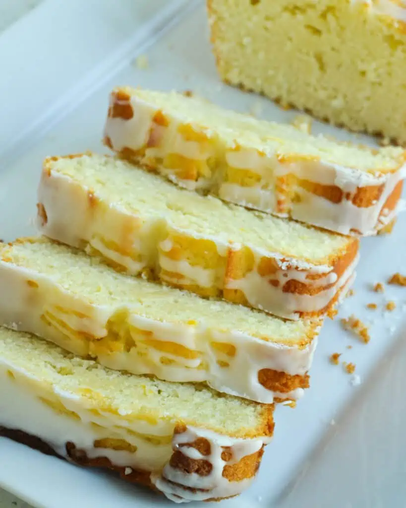 A quick and easy tasty Lemon Pound Cake made with fresh lemons and lemon zest, sliced, and topped with a tangy two-ingredient lemon glaze.