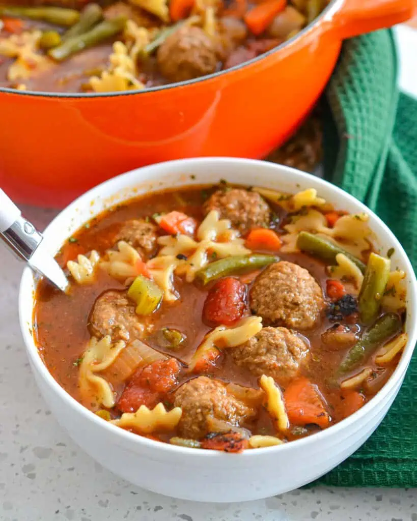 This delicious Meatball Soup Recipe brings meatballs and pasta together with onions, carrots, celery, and green beans in a hearty beef broth that has been perfectly seasoned with Italian spices.