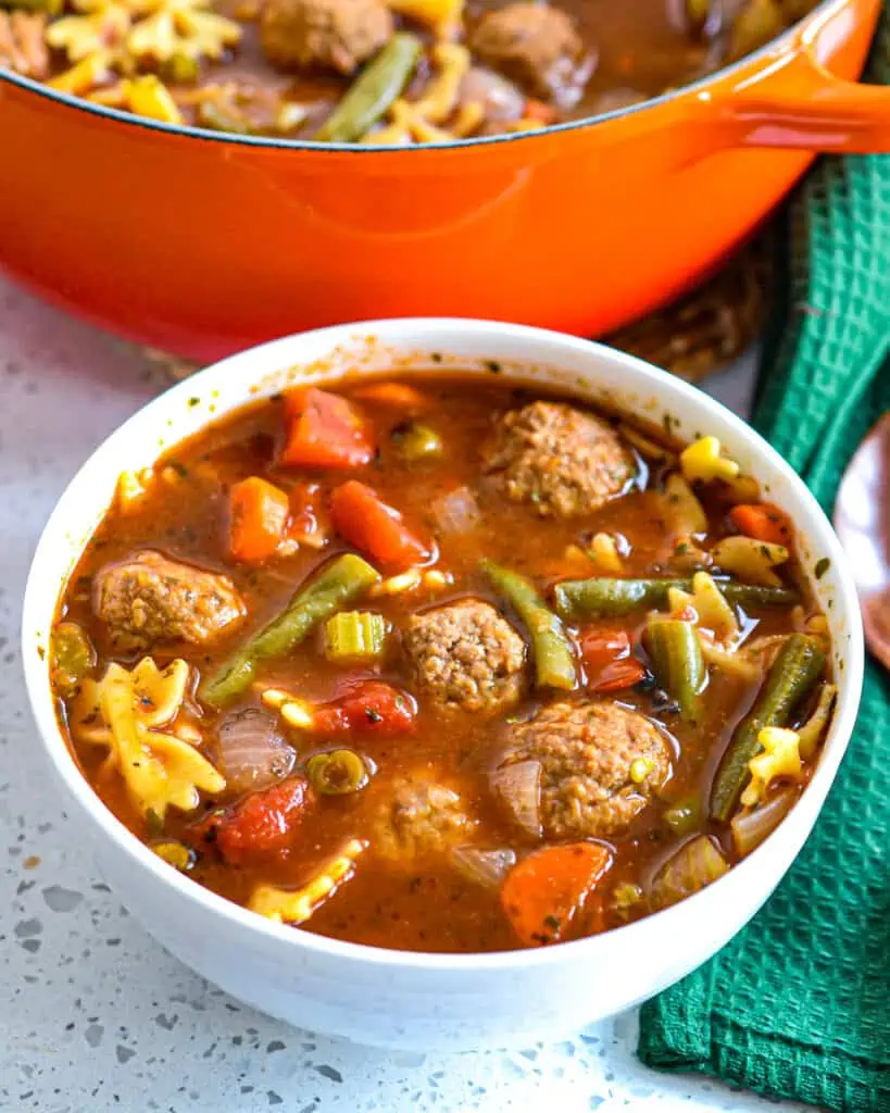 This delectable tender meatball soup combines onions, carrots, celery, and green beans with Italian seasonings in a rich tomato beef broth with Italian meatballs and mini Farfalle Pasta.