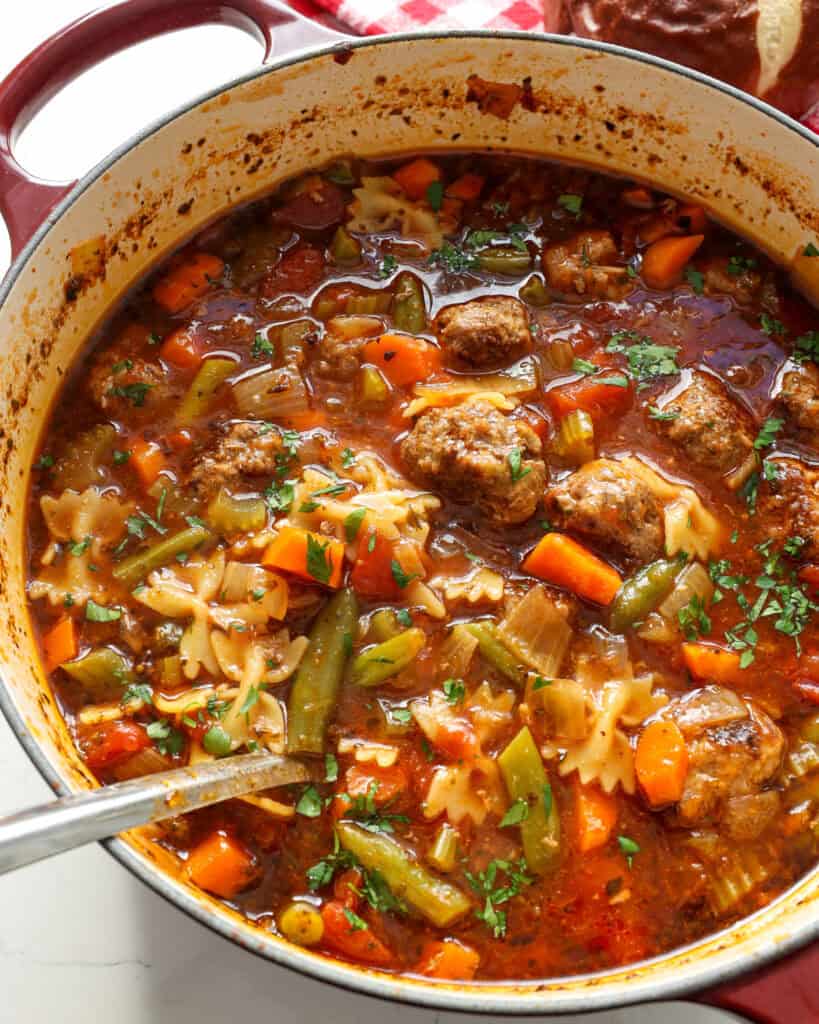 A Dutch oven full of meatball soup. 