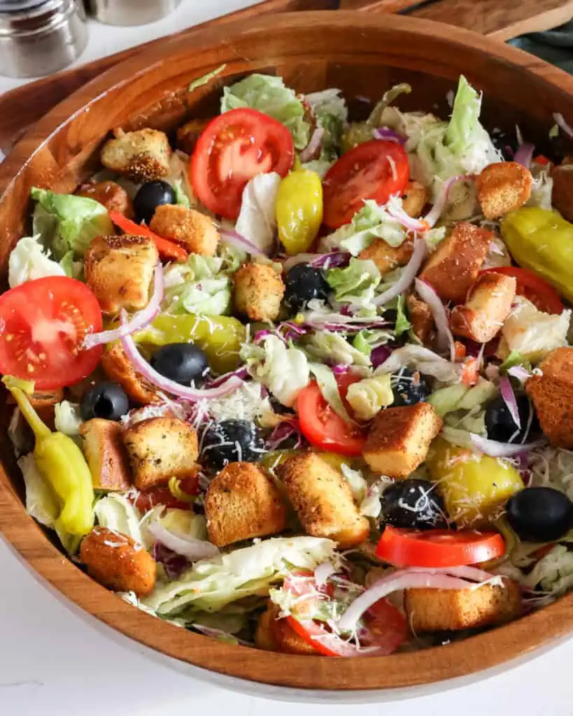 Learn the secret to crafting a healthy and delicious version of the popular Olive Garden salad at home with easy ingredients and their signature dressing. 