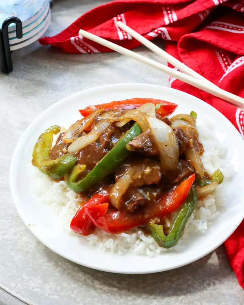 Pepper steak is a Chinese stir-fry dish of thinly sliced beef with green and red bell peppers and onions in a savory ginger sauce. 