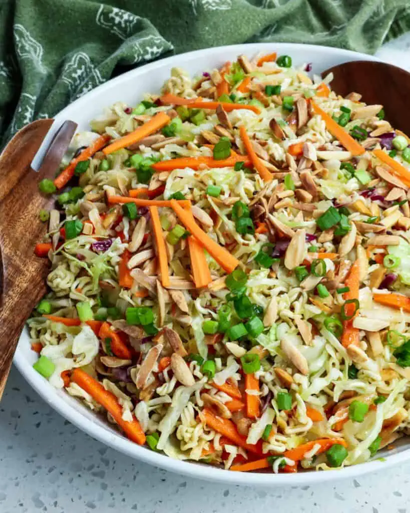 This crunchy Ramen Noodle Salad is loaded with cabbage, carrots, green onions, toasted almonds, and ramen noodles all tossed in an easy garlic honey ginger dressing.  
