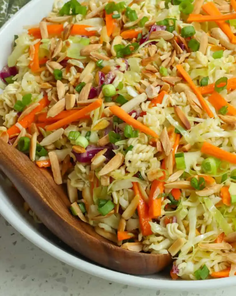 This crunchy Ramen Noodle Salad combines green cabbage, red cabbage, ramen noodles, green onions, carrots, and toasted almonds all tossed in a honey garlic ginger sesame dressing