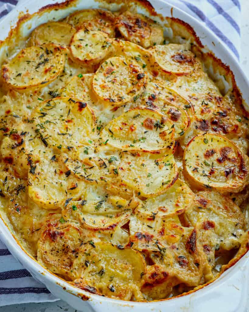 These delicious Classic Scalloped Potatoes are made easily with sautéed onions and garlic, creamy sauce, fresh herbs, and plenty of salt and fresh ground black pepper. 