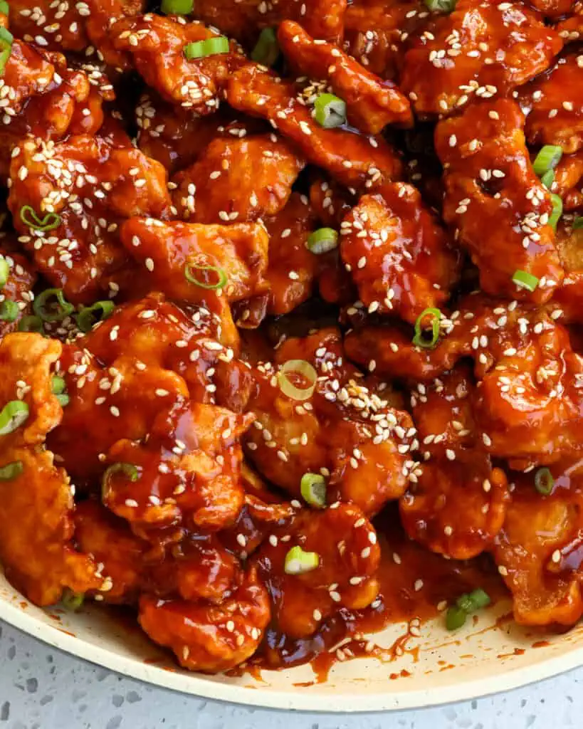 Sesame chicken is tender chunks of chicken dipped in eggs and cornstarch and fried up crispy, then tossed in a sweet and salty sauce.