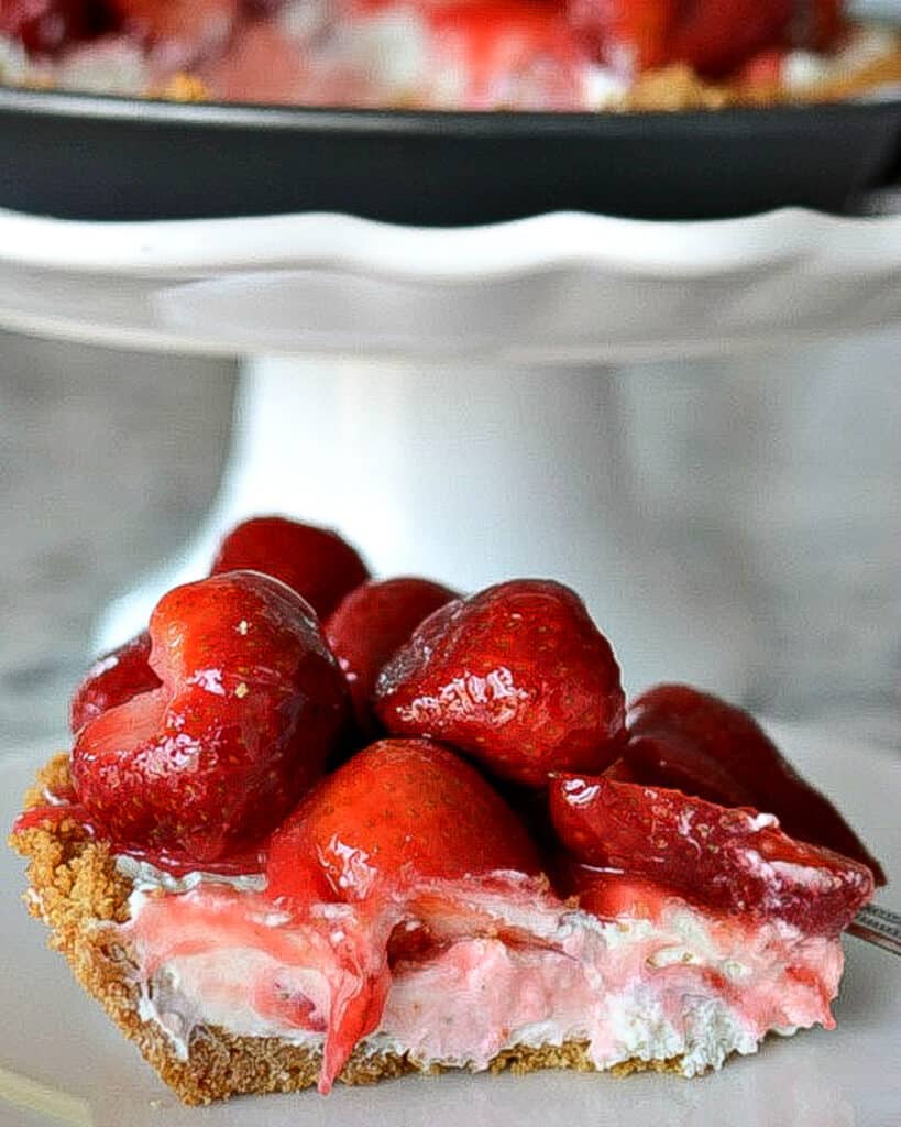 This family-friendly, easy cream cheese-based pie is nestled in a sweetened buttery graham cracker crust and topped with lightly glazed strawberries.