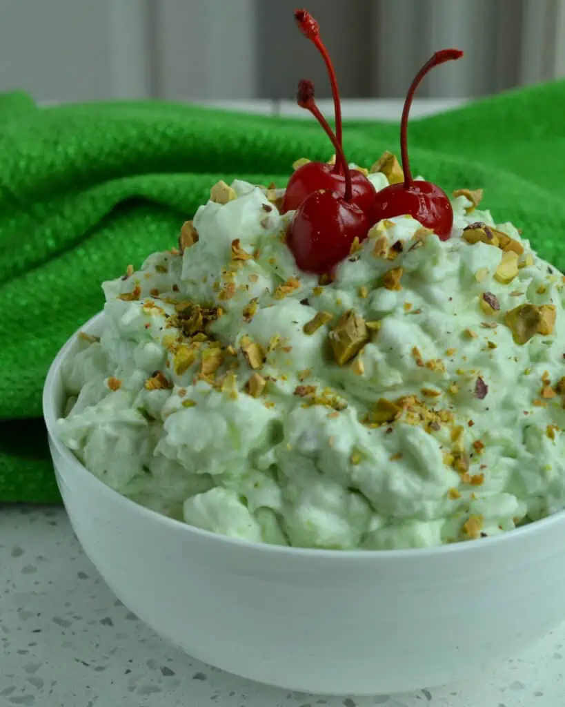 Watergate salad is a retro pistachio salad recipe from 1975 made with crushed pineapple, pistachio pudding mix, pistachio nuts, mini marshmallows, and whipped cream. 
