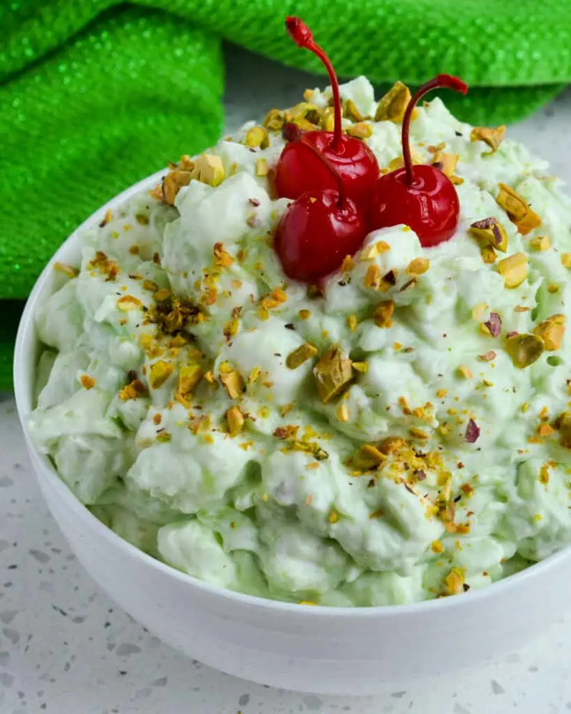 This classic Watergate Salad Recipe, also known as Pistachio Delight and Green Fluff, is a fresh blast from the past with the flavors of crushed pineapple, pistachio pudding, pistachio nuts, mini marshmallows, and fresh whipped cream. 