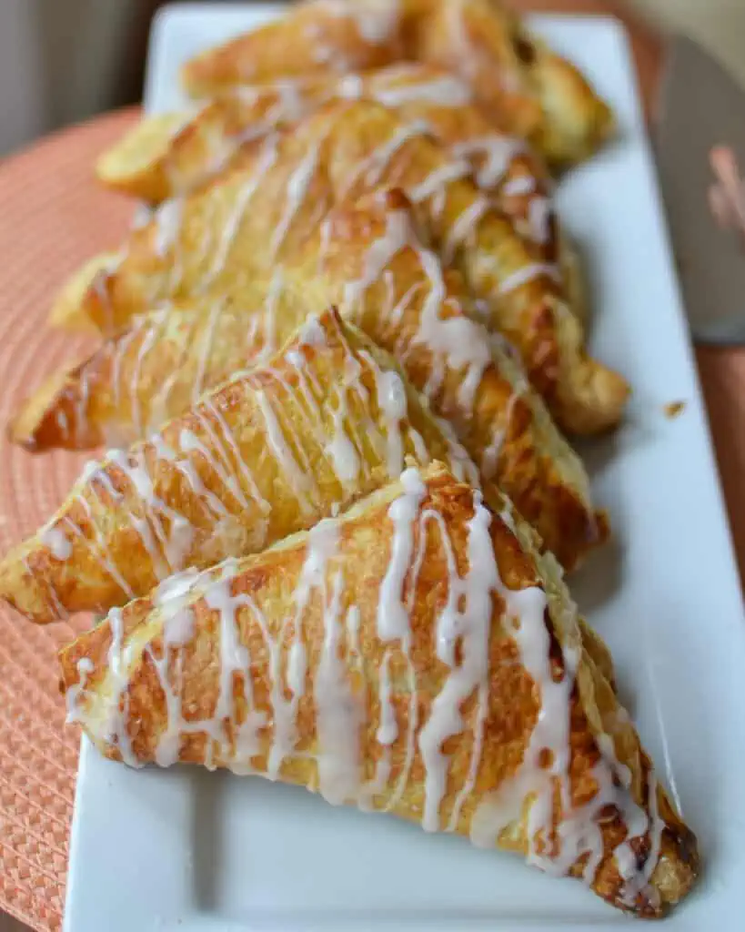 Fresh baked apple turnovers on a serving platter.