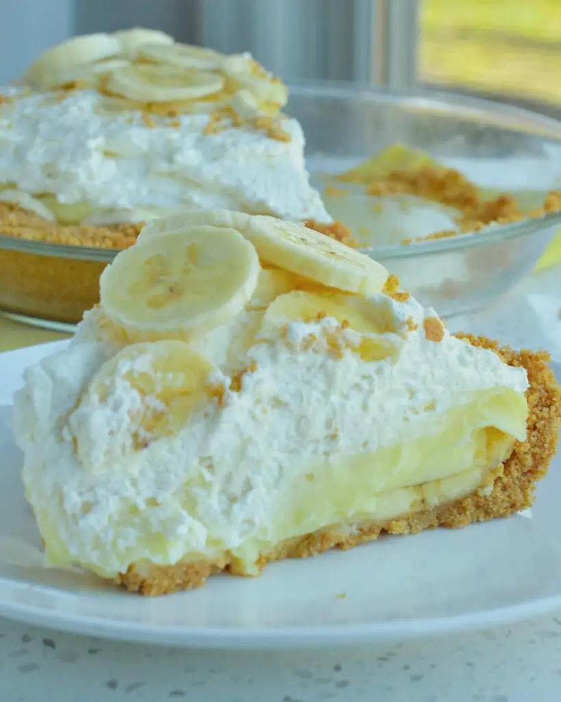 This Banana Cream Pie Recipe has a three-ingredient graham cracker crust followed by an easy homemade vanilla pudding loaded with fresh bananas and topped with homemade whipped cream. 