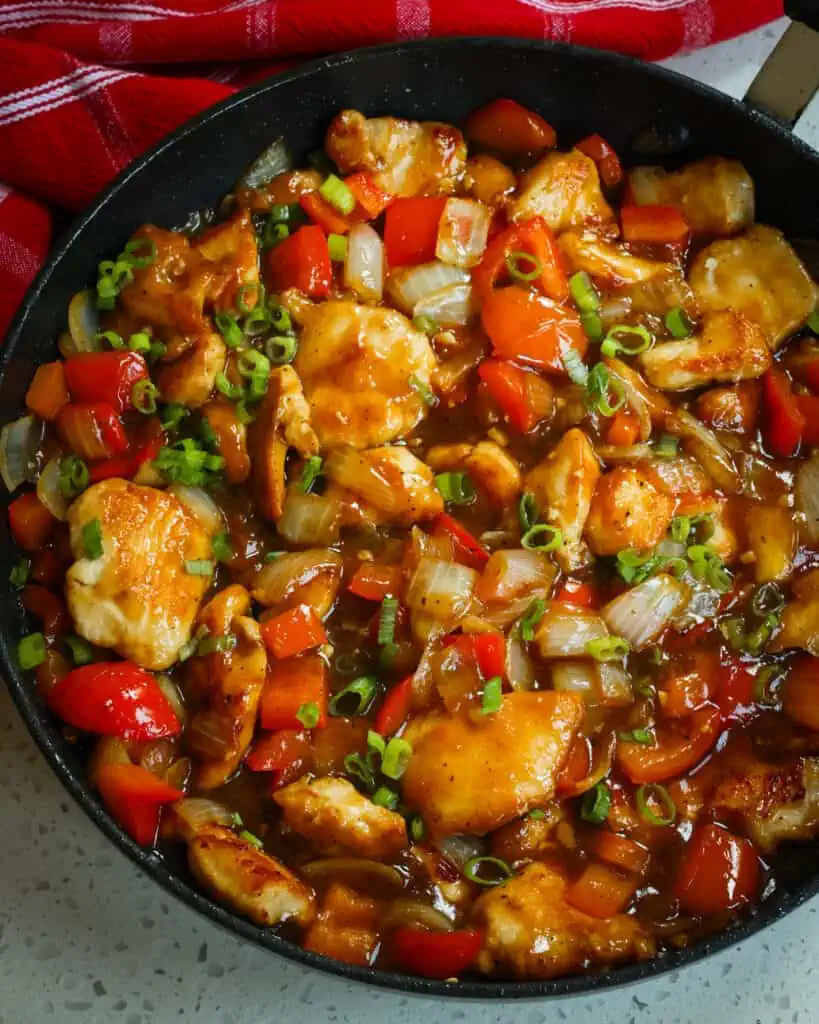 Black Pepper Chicken combines stir-fried chicken breasts, onions, and red bell pepper seasoned with garlic and ginger in a sweet and savory black pepper sauce.