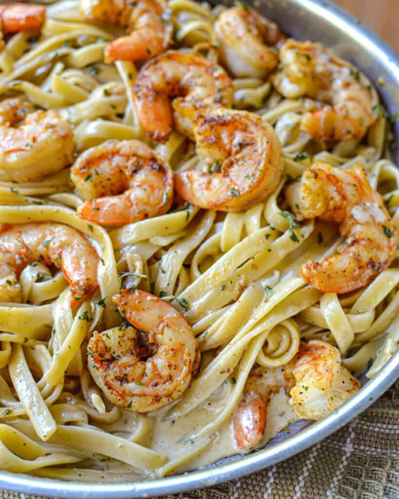 A close up view of Cajun shrimp pasta in a skillet.