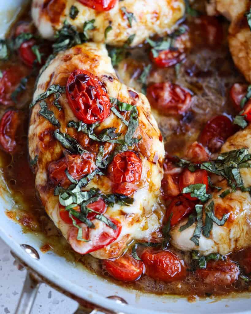 Caprese chicken in a large skillet gray skillet. 