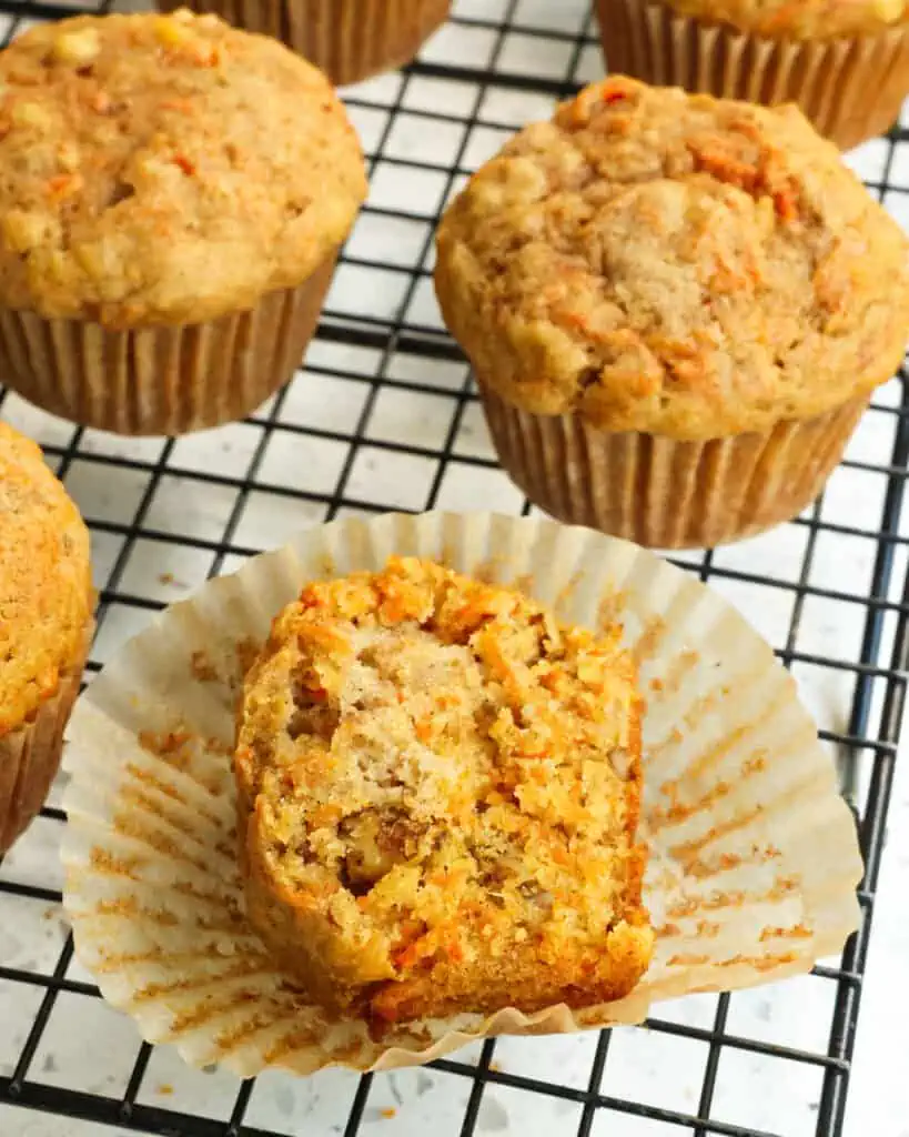 These are sky high Bakery style Carrot Muffins dotted with shredded carrots, crushed pineapple, and walnuts spiced with ground cinnamon and ground ginger.