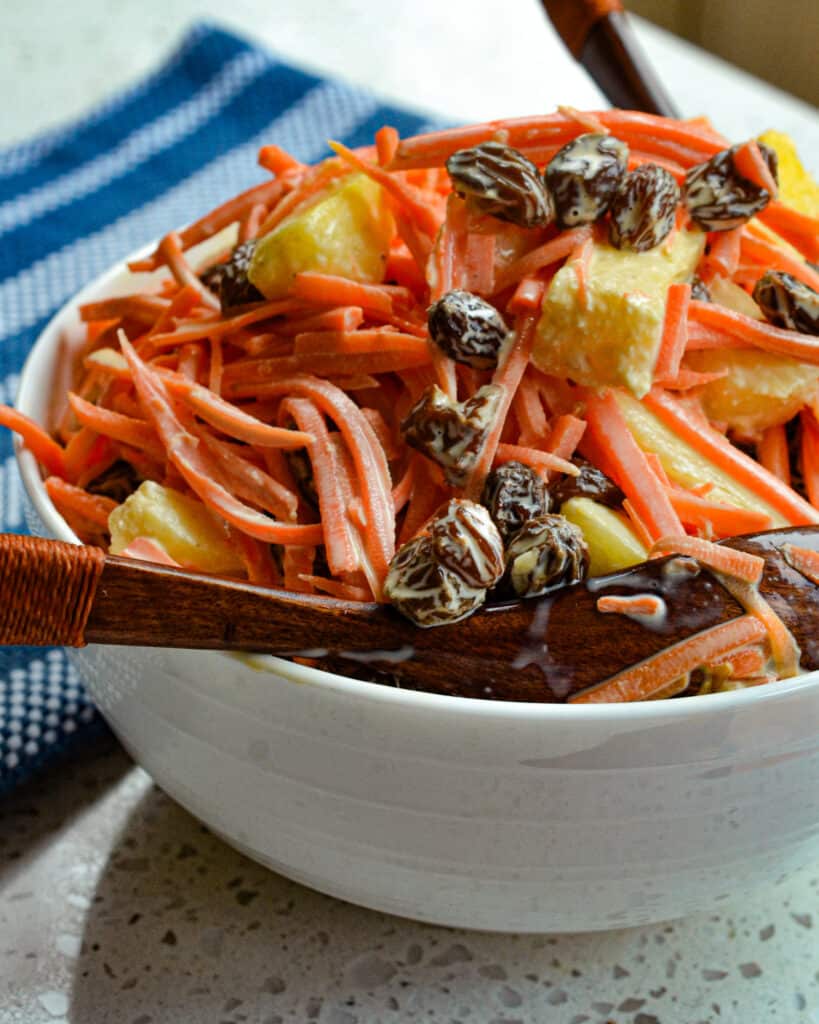 This fresh Carrot Salad is lightly sweetened with all natural honey and freckled with plump raisins and crisp pineapple.