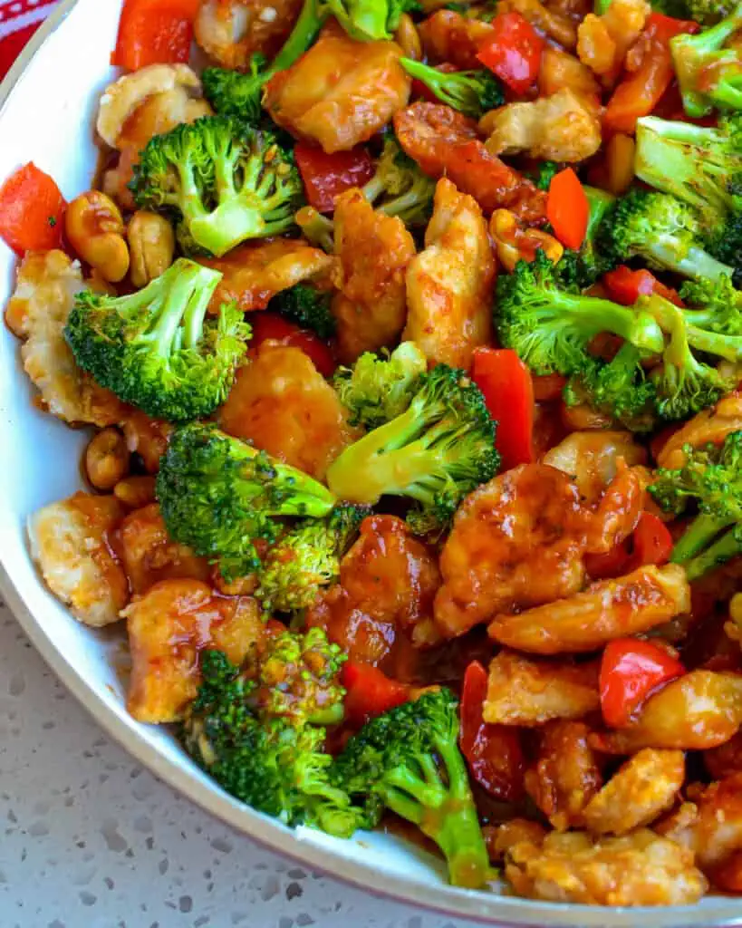 This Cashew Chicken combines crispy pan fried chicken breast pieces with sweet red bell pepper, tender crisp broccoli, and roasted cashews in a slightly spicy sweet and tangy sauce. 