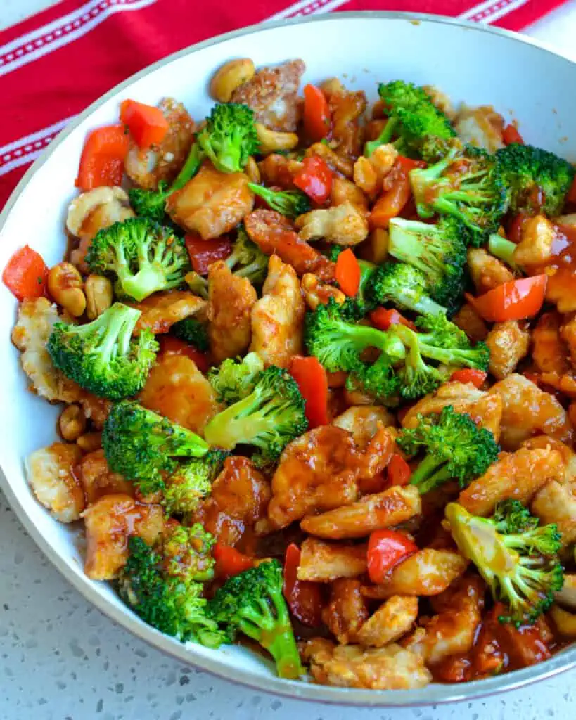 This delectable Cashew Chicken recipe brings crispy pan-fried chicken bites, sweet red bell pepper, crisp-tender broccoli, and roasted cashews together in a spicy, salty, and sweet mouth-watering sauce.