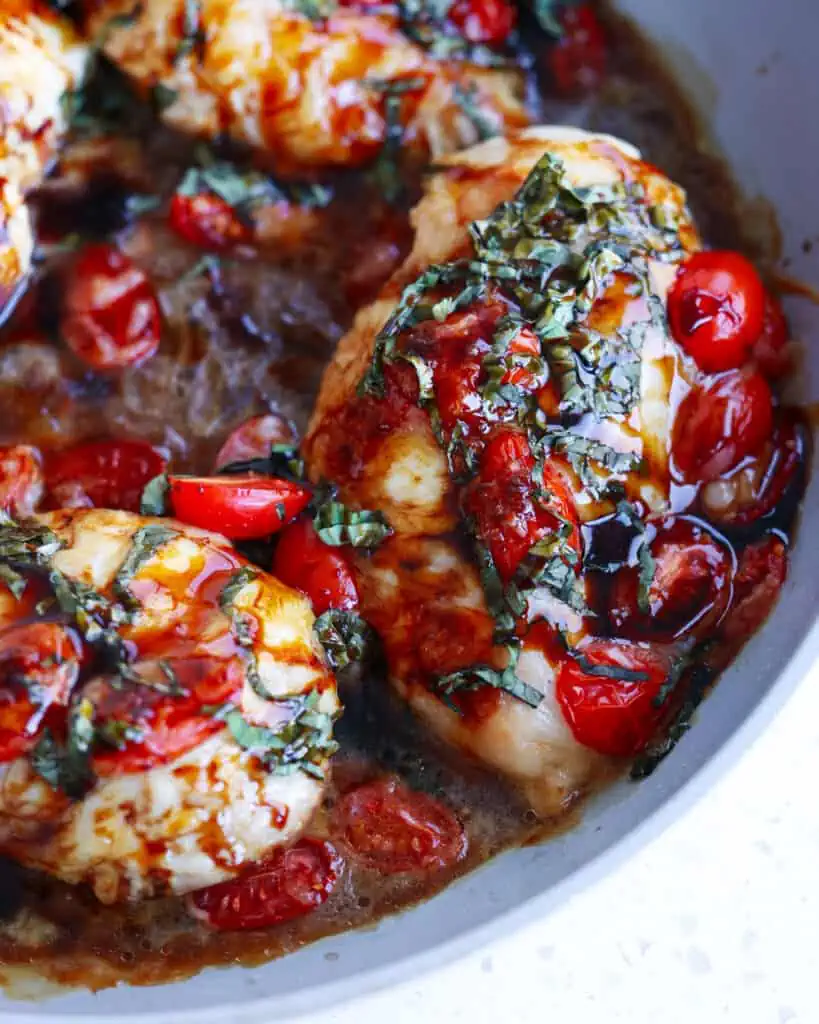 This flavorful Chicken Caprese Recipe combines browned chicken breasts, melted mozzarella cheese, sun-ripened tomatoes, and fresh basil all drizzled with a sweet balsamic glaze.