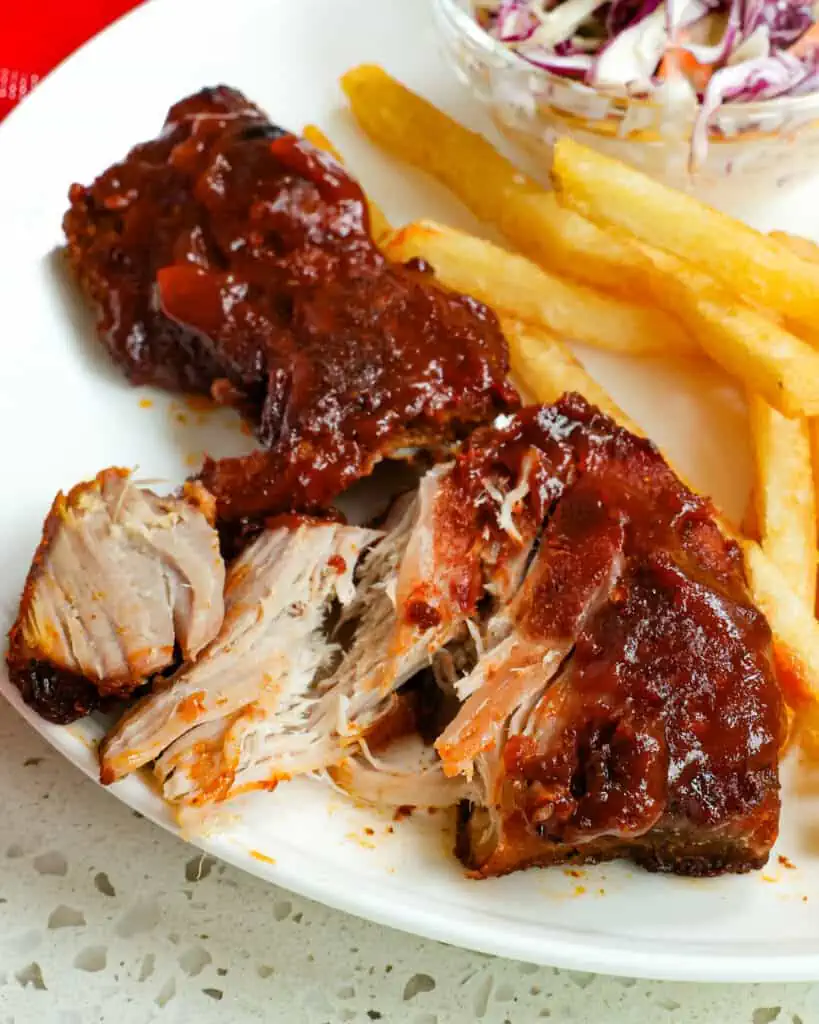 These tender and juicy Country Style Ribs are coated with an easy dry rub, baked low and slow, and basted with homemade barbecue sauce.
