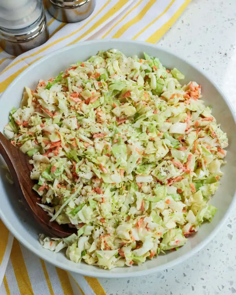 Add the dressing to the shredded cabbage mixture and stir to combine. Season with salt and pepper to taste.