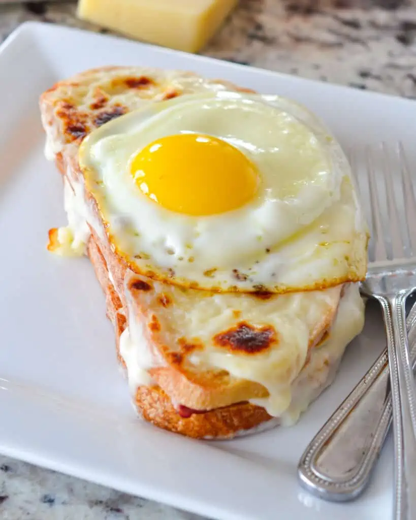 Croque Madame is a delectable toasted sandwich filled with ham and creamy Mornay sauce and topped with a sunny side-up egg. It's a perfect brunch sandwich for any weekend. 
