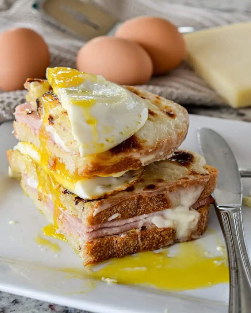 Croque Madame is composed of crisp bread, Mornay sauce, ham, cheese, and a delicious fried egg