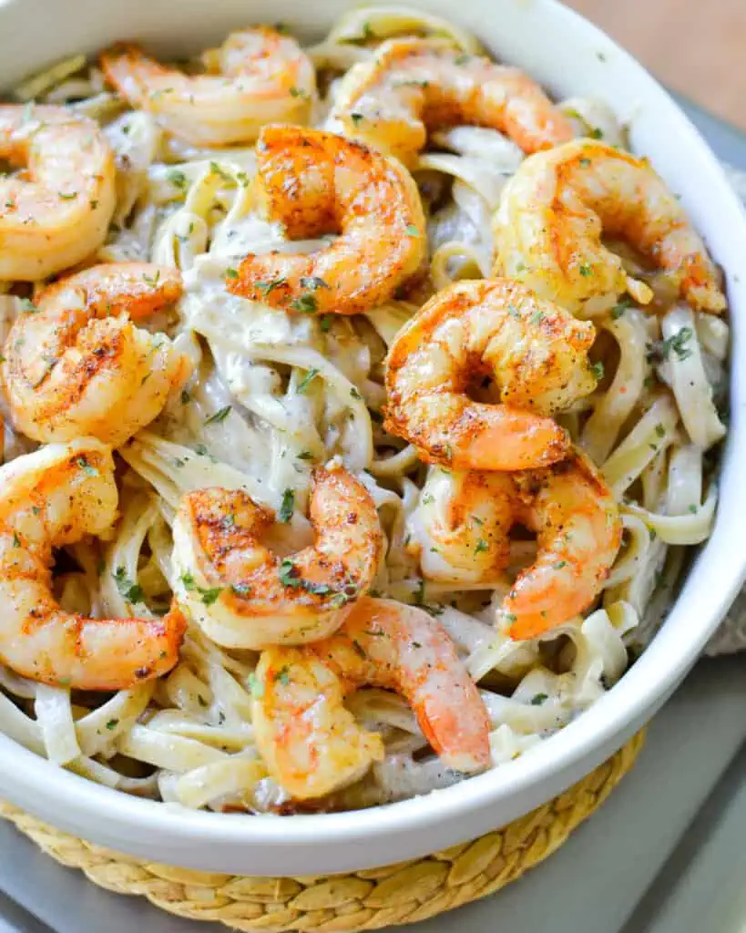 This easy family friendly fettuccine pasta combines  pan seared garlic shrimp with a creamy Cajun seasoned pasta sauce.