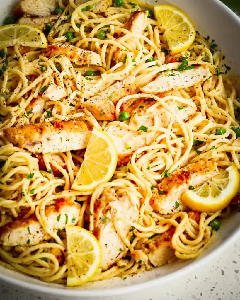 Toss the spaghetti with the chicken and add fresh lemon slices and chopped parsley.  