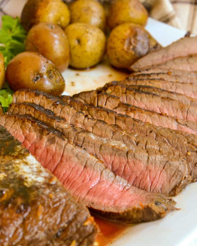 Thin slices of pan seared steak with boiled baby potatoes.