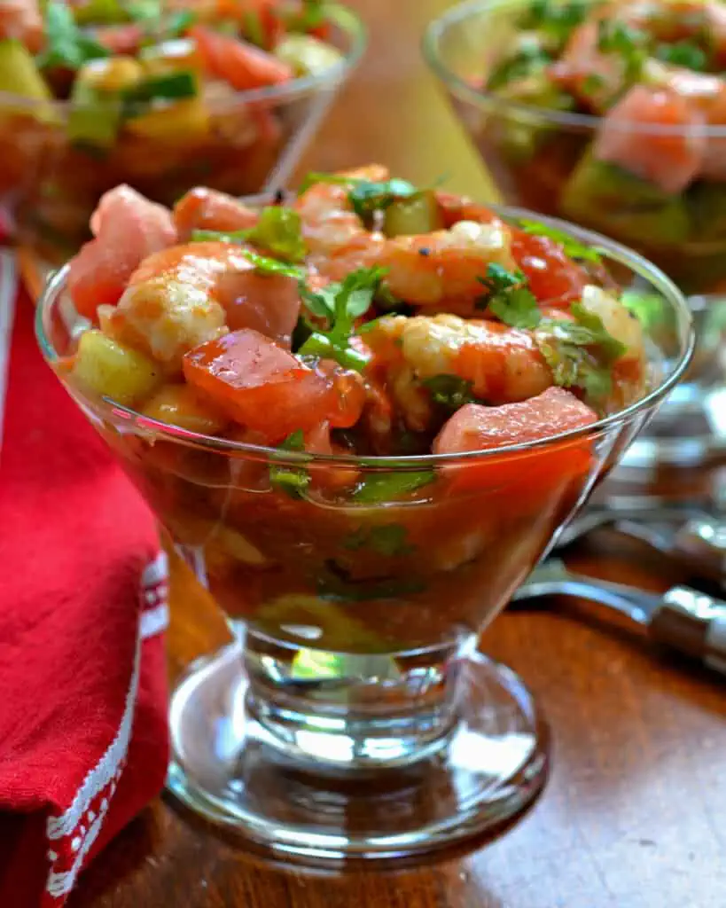 Mexican Shrimp Cocktail is shrimp, onions, celery, cucumbers, tomatoes, avocado, and jalapenos in a tomato dressing. 