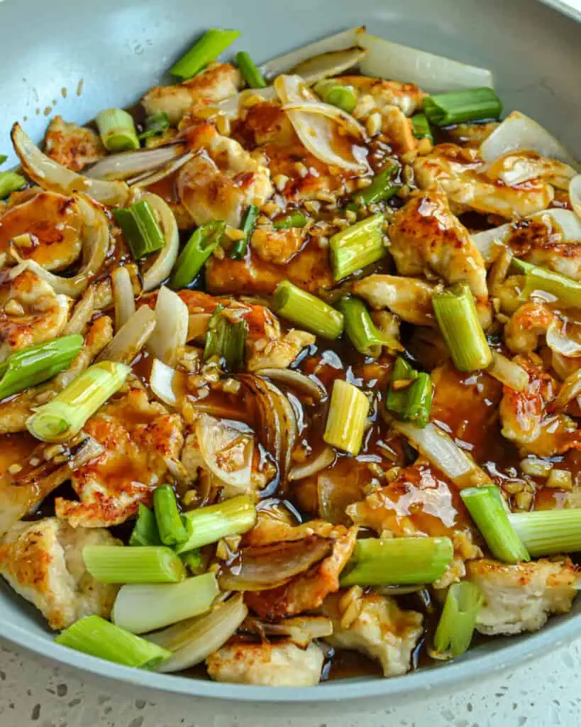 This Mongolian Chicken Recipe combines crispy stir-fried chicken, onions, and scallions in an easy-to-make sweet and salty garlic ginger sauce. 
