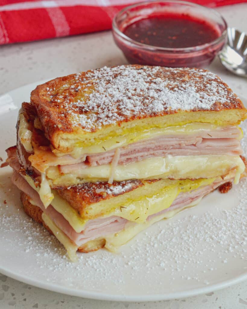 This classic Monte Cristo sandwich is ham, turkey, and cheese layered between bread, then dipped in an egg mixture and fried. For extra flavor, serve with raspberry preserves for dipping. The Monte Cristo sandwich can be served for breakfast, lunch, or dinner!