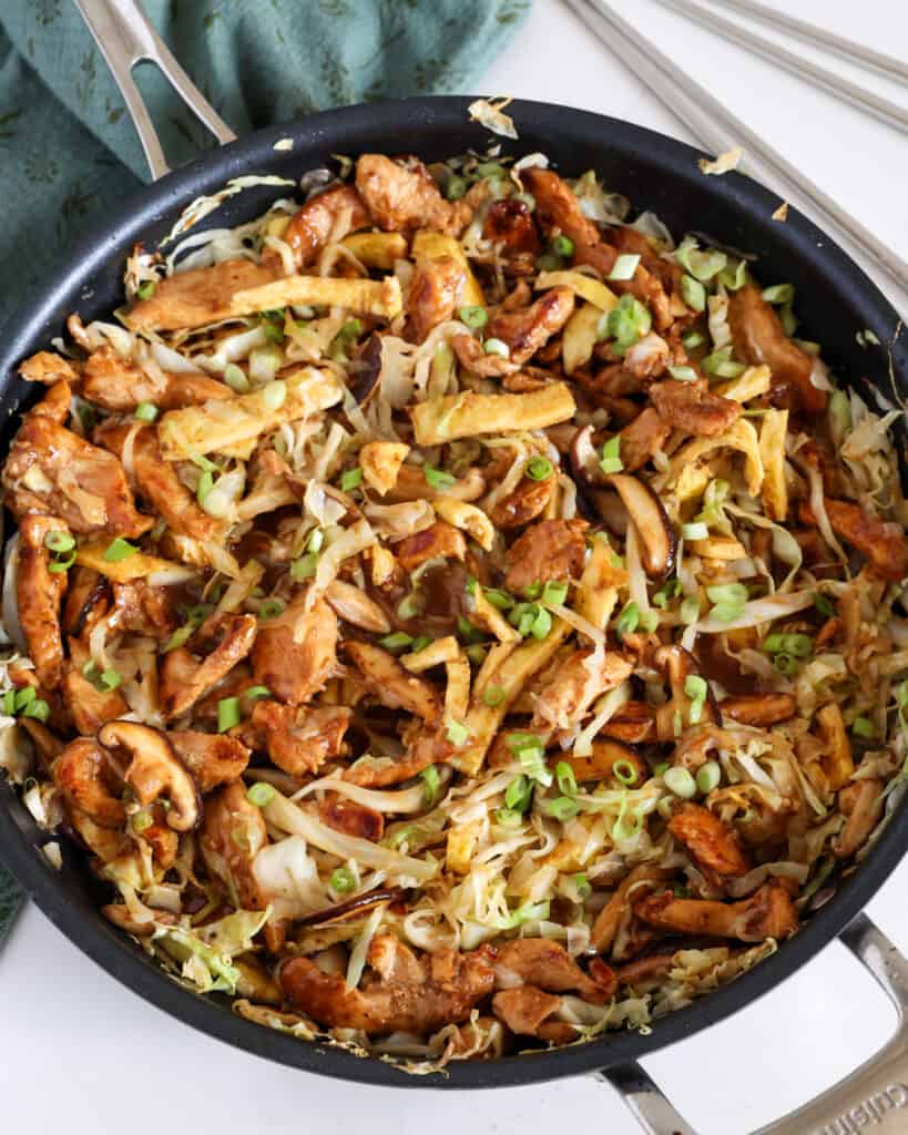 Moo Shu Chicken combines tender marinated chicken stir-fried with cabbage, mushrooms, and eggs in a savory sauce with the flavors of garlic and ginger.