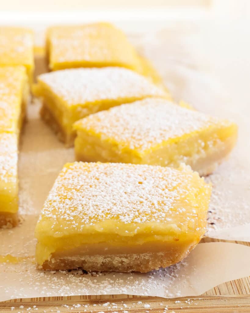 These tangy lemon squares are the ultimate treat. They have a simple shortbread crust, fresh lemon curd, and a dusting of powdered sugar.