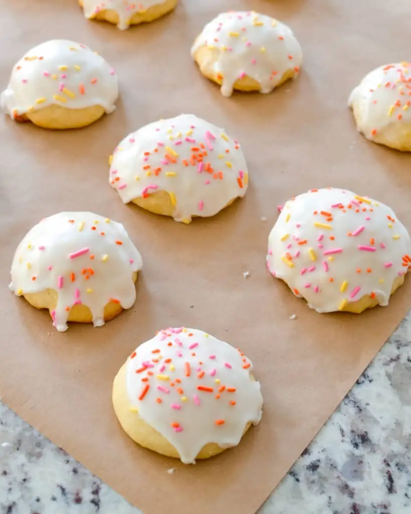 Lemon Ricotta Cookies are soft cake like cookies made with ricotta cheese and fresh lemons.  They are covered with a sweet lemon glaze and sprinkles.