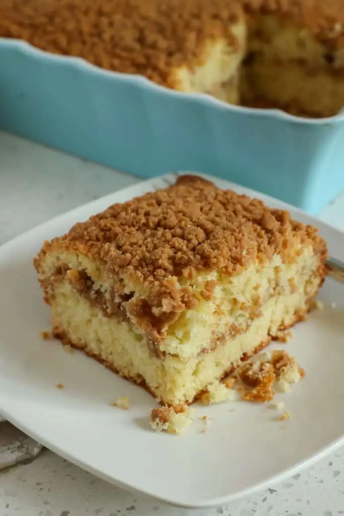 This Sour Cream Coffee Cake is a rich, decadent, buttery cake with a generous layer of walnut streusel through the center and over the top. 