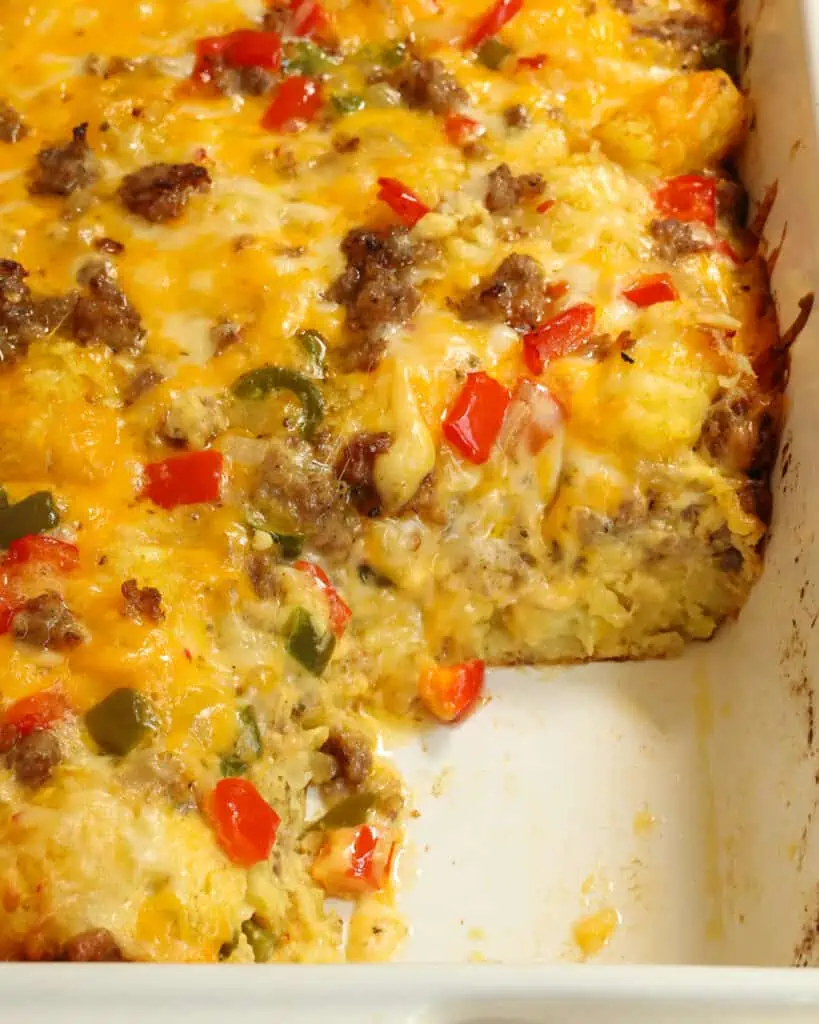 Tater tot breakfast casserole with a single slice removed. 