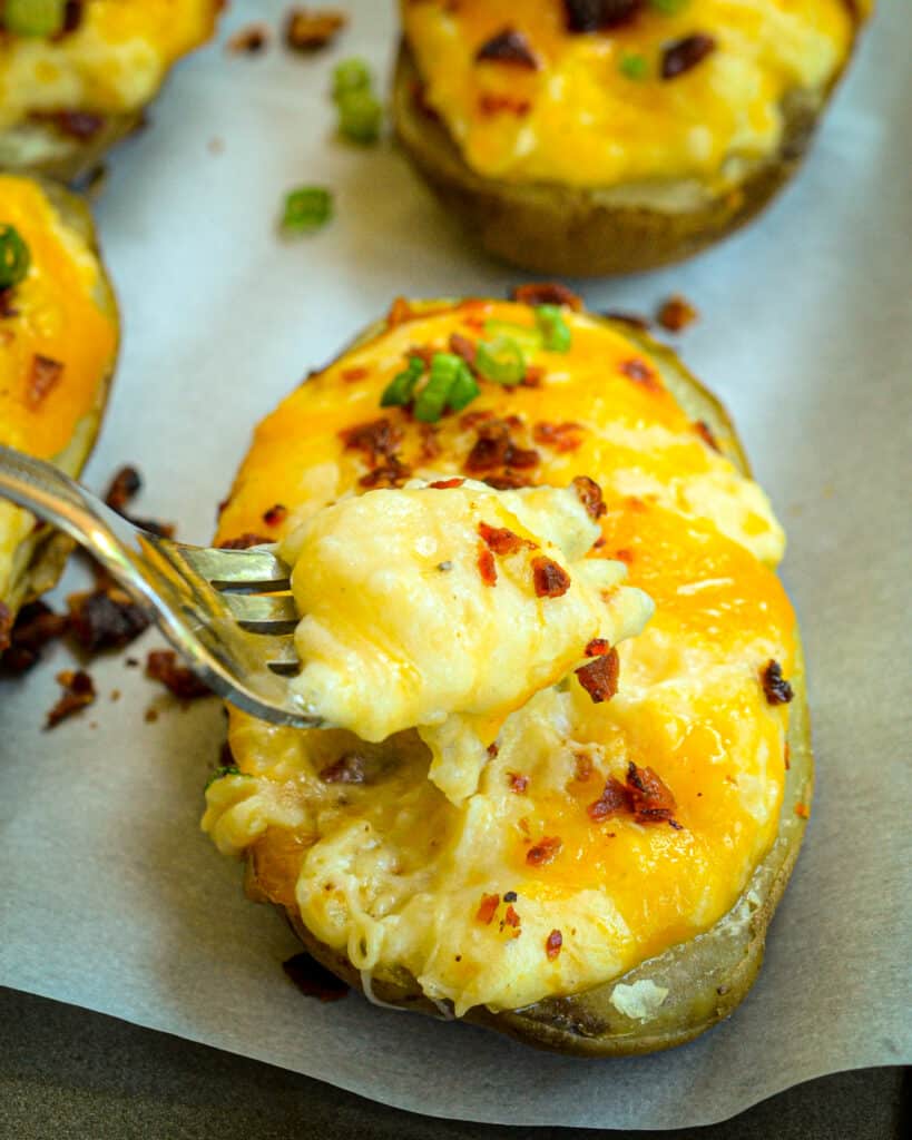 This easy twice-baked potato recipe is loaded with crispy bacon and melted cheese and topped with green onions. 