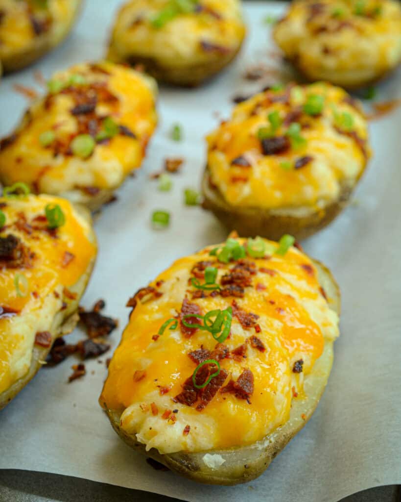 Twice Baked Potatoes are a classic side to add to just about any meal, from steak to sandwiches, chicken, and more—delicious, creamy potatoes topped with crispy bacon, scallions, and sour cream.
