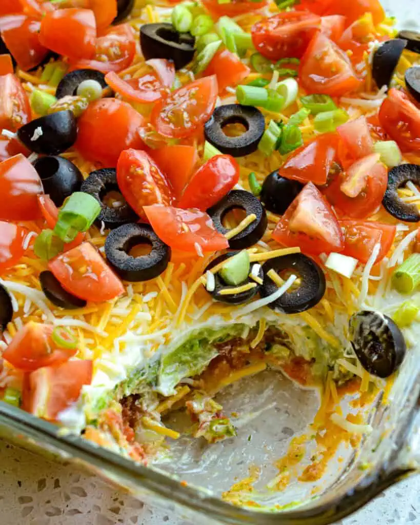Classic 7 layer dip in a casserole dish.
