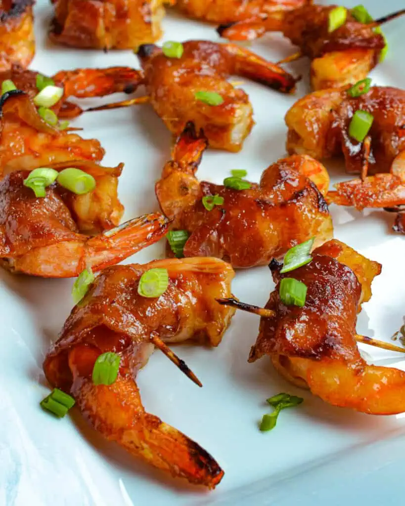 An easy-to-make appetizer recipe that is always a hit with family and friends. The slightly spicy sweet Asian sauce takes these Bacon Wrapped Shrimp off the flavor charts.