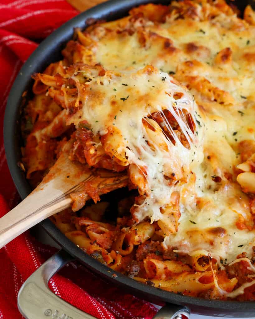 Baked Mostaccioli Baked Mostaccioli combines Italian sausage, peppers, onions and marinara all blanketed in mozzarella and provolone cheese.