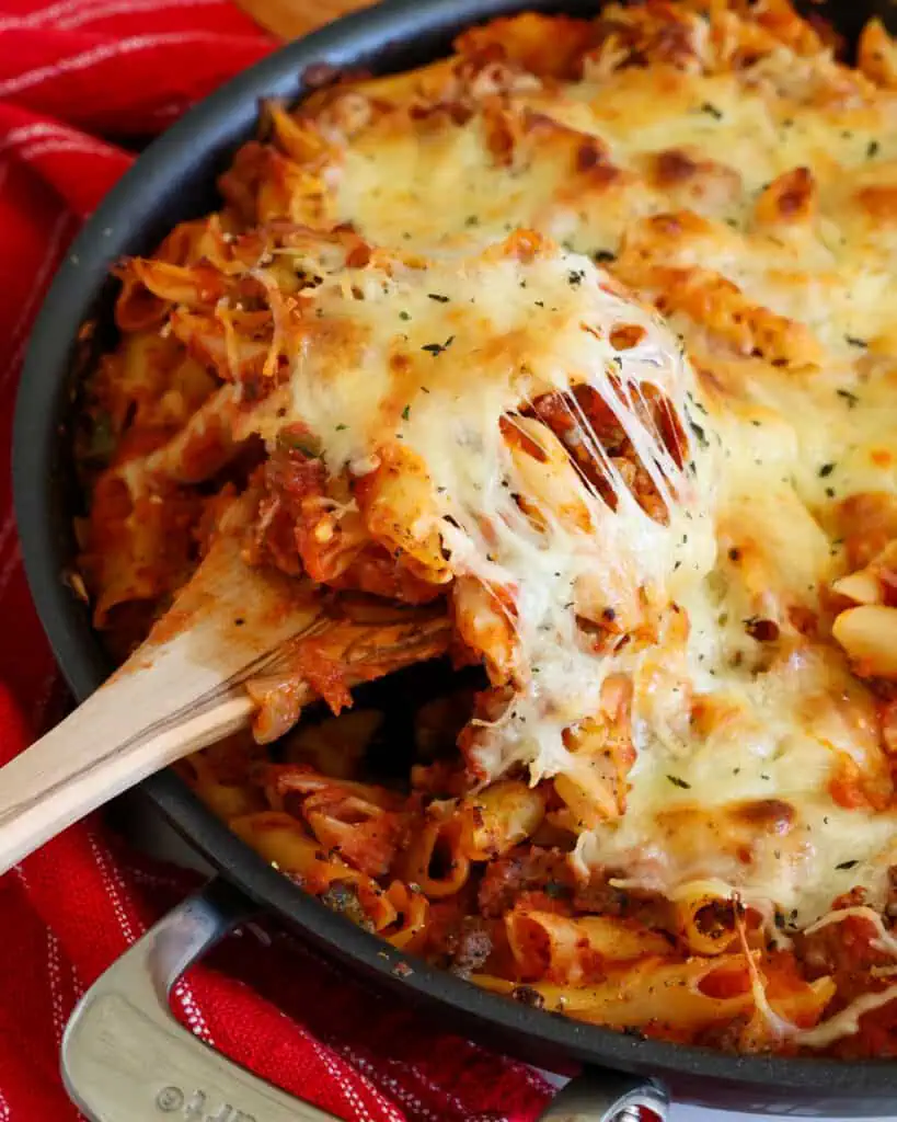 Baked Mostaccioli Baked Mostaccioli combines Italian sausage, peppers, onions and marinara all blanketed in mozzarella and provolone cheese.