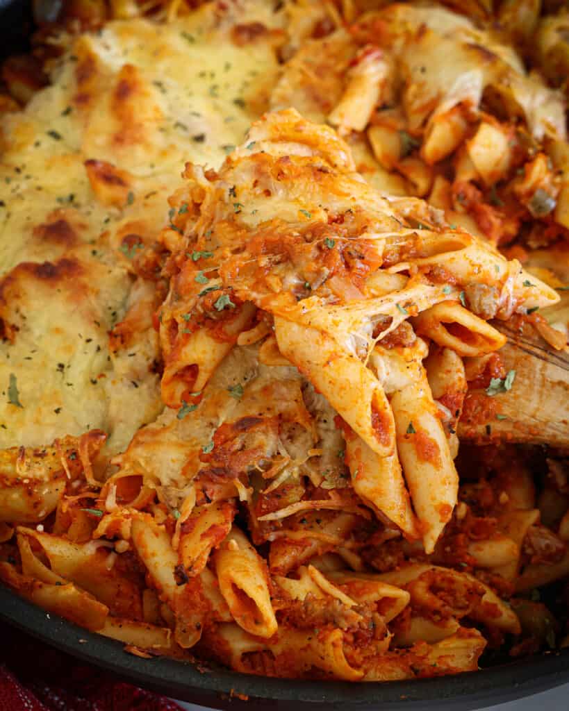 Classic Baked Mostaccioli This delicious baked mostaccioli contains layers of fresh Italian sausage, sweet onions, minced garlic, and marinara. It is then topped with Parmesan and mozzarella cheese.