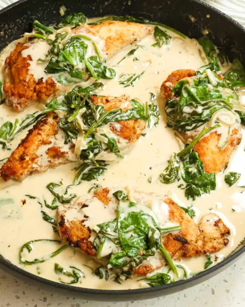 Chicken Florentine combines lightly breaded golden brown chicken breasts, shallots, spinach, and garlic in a creamy white wine sauce, all sprinkled with Parmesan Cheese. 